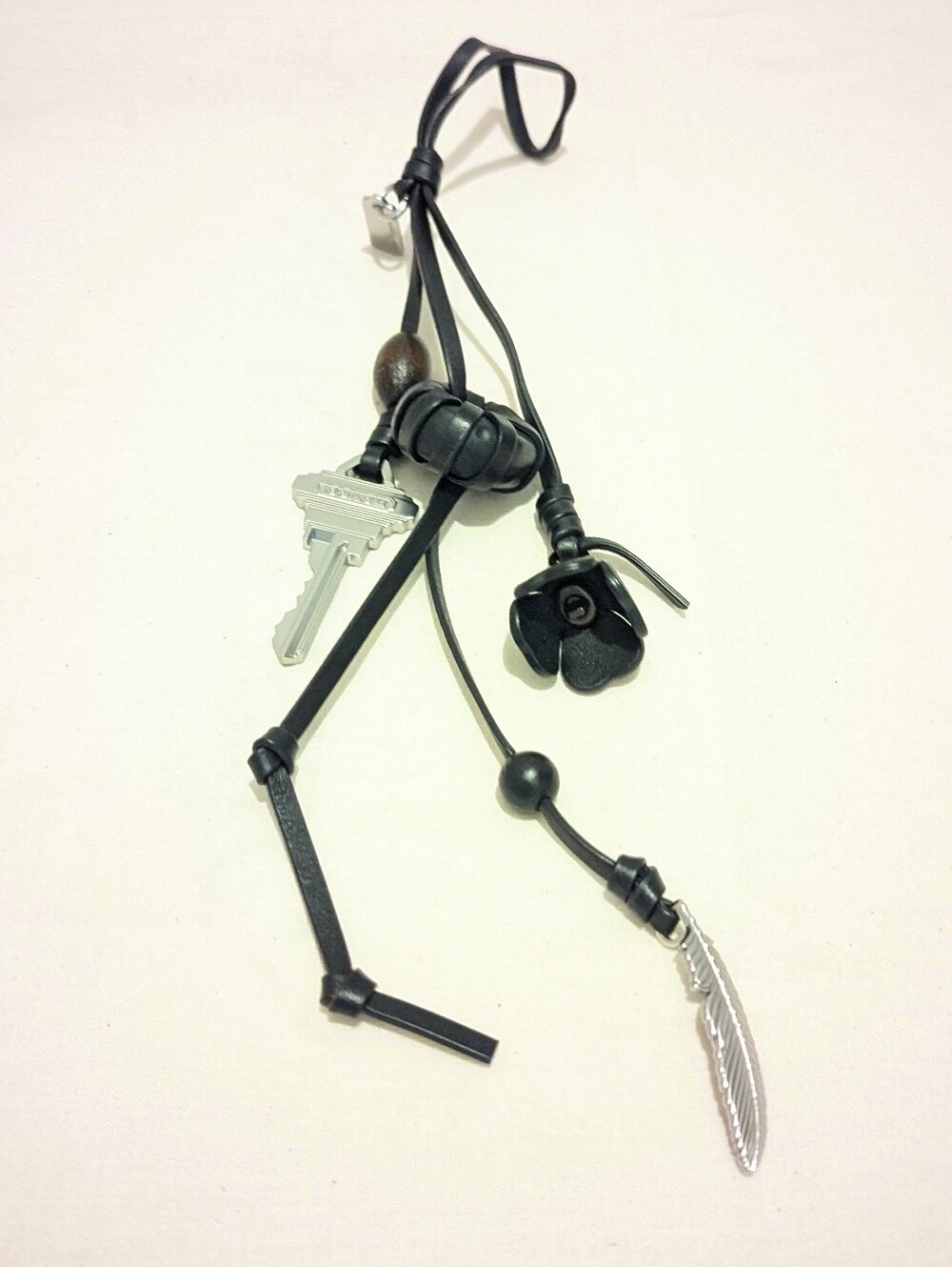 Coach Black Leather Charm Keychain with Silver Feather Accent